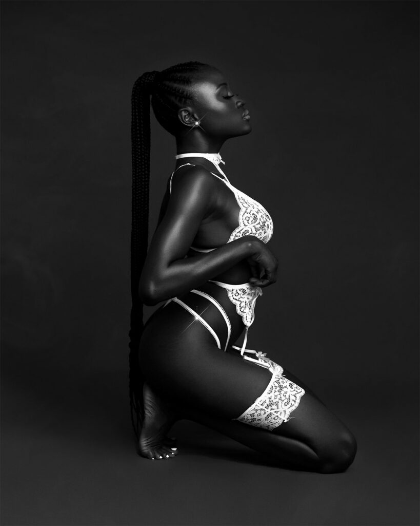 Image of a woman of color wearing a contrasting white set of lingerie by Olamide Gabriel on Unsplash